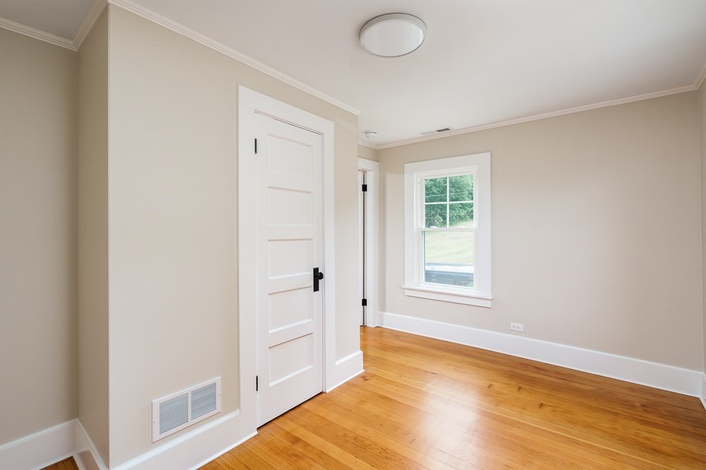69 High Street Southampton, MA 01073 - Photo 35 of 42 a view of an empty room with wooden floor and a window