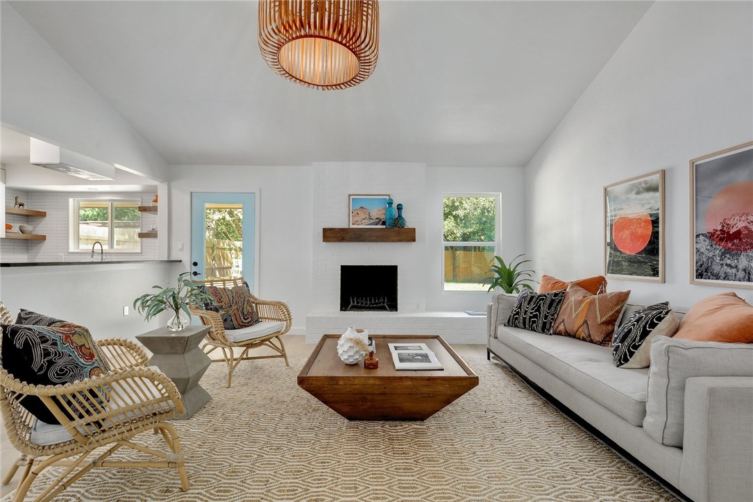 a living room with furniture a rug and a fireplace