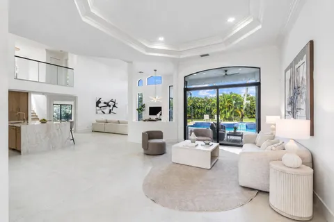 a living room with furniture large window and outer view