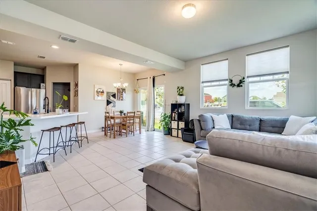 a living room with furniture and dining table