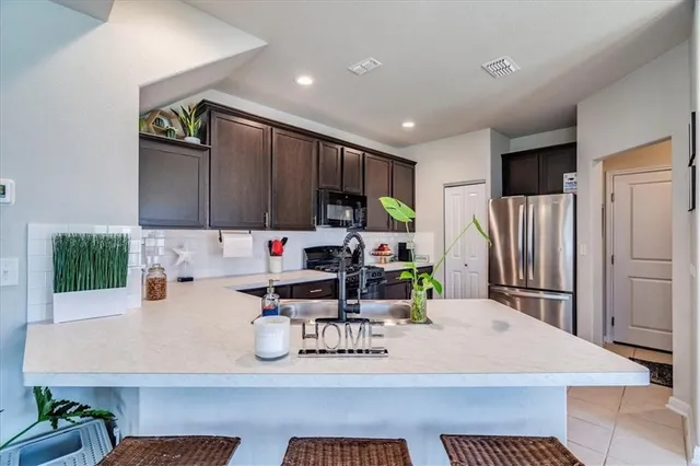 a kitchen with a sink a stove and a wooden cabinets