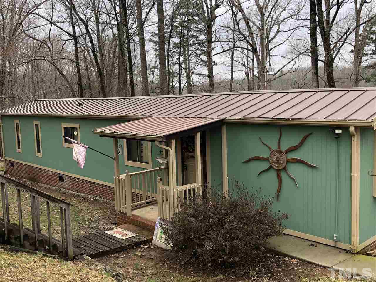 6119 Virgilina Road Roxboro, NC 27574 - Photo 1 of 11 a front view of a house with garden