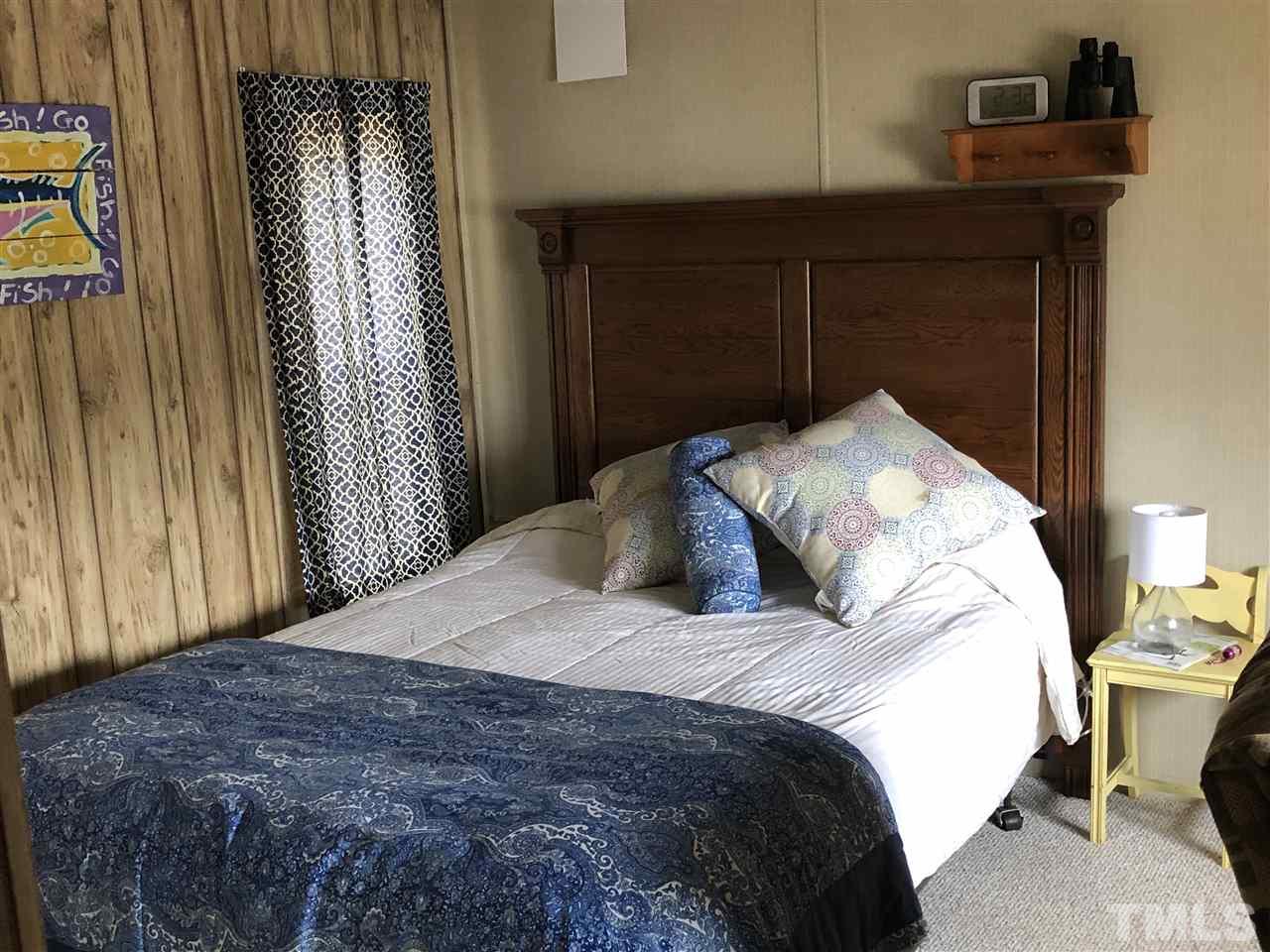 6119 Virgilina Road Roxboro, NC 27574 - Photo 11 of 11 a bedroom with a bed and a window