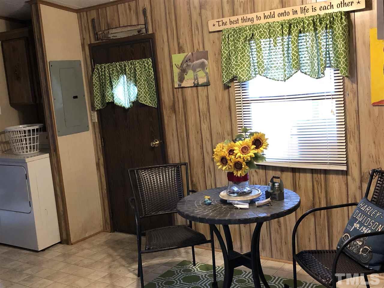 6119 Virgilina Road Roxboro, NC 27574 - Photo 10 of 11 a view of a dining room with furniture window and wooden floor