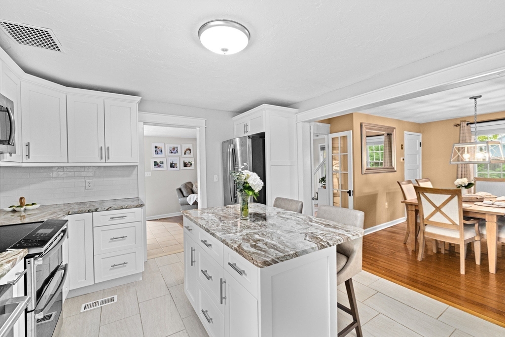 983 Webster Street Hanover, MA 02339 - Photo 12 of 41 a open kitchen with white cabinets and stainless steel appliances