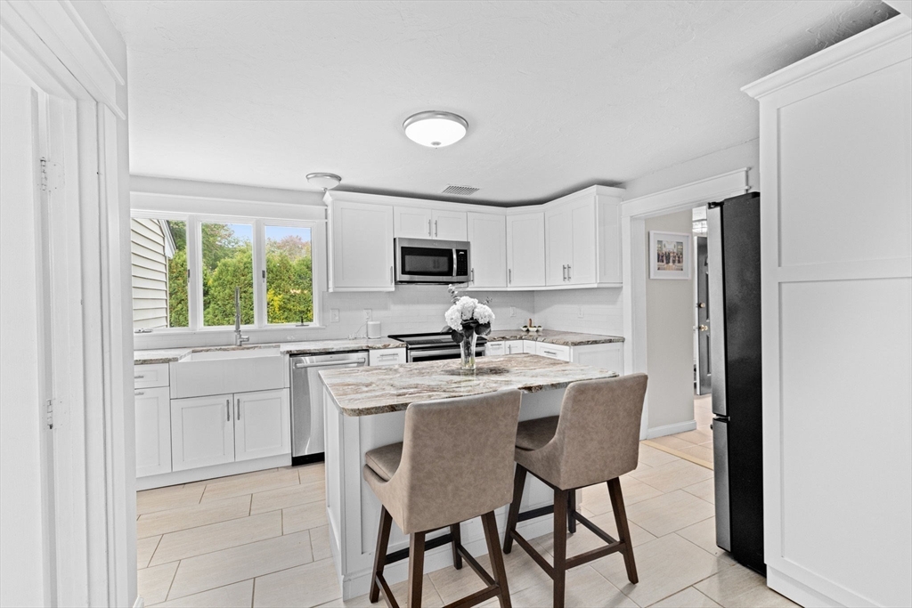 983 Webster Street Hanover, MA 02339 - Photo 15 of 41 a kitchen with a stove a sink and a refrigerator