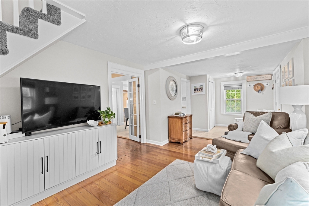 983 Webster Street Hanover, MA 02339 - Photo 6 of 41 a living room with furniture and a flat screen tv