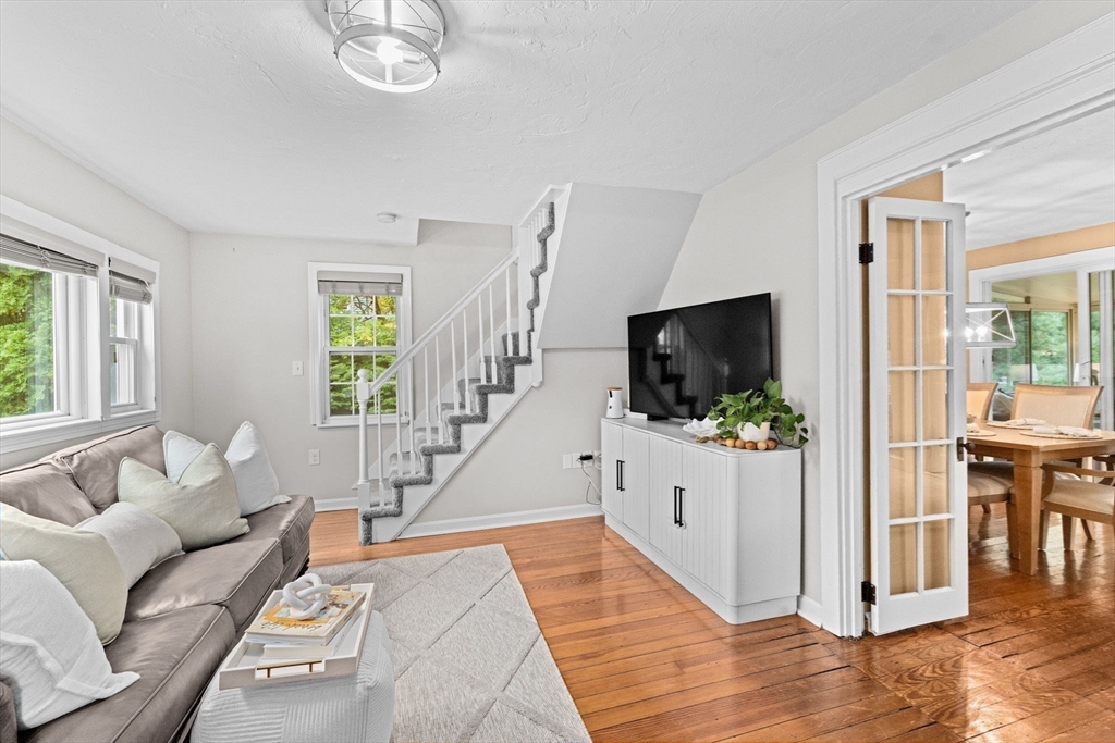 983 Webster Street Hanover, MA 02339 - Photo 7 of 41 a living room with furniture and a flat screen tv
