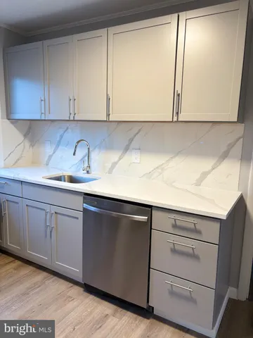 a kitchen with appliances cabinets and a sink