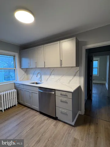 a kitchen with granite countertop a sink and a stove top oven