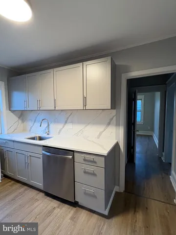 a kitchen with stainless steel appliances granite countertop a sink and cabinets