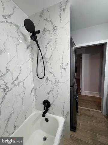 a bathroom with a tub and shower