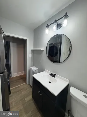 a bathroom with a sink a mirror and a toilet