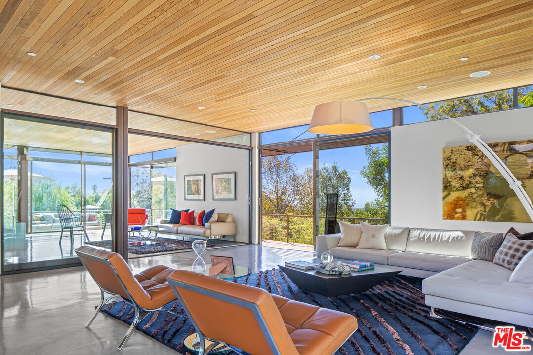 12321 Rochedale Lane Los Angeles, CA 90049 - Photo 11 of 46 a living room with patio furniture and a large window