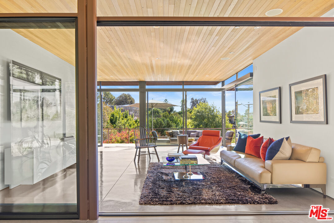 12321 Rochedale Lane Los Angeles, CA 90049 - Photo 14 of 46 a living room with furniture and a large window