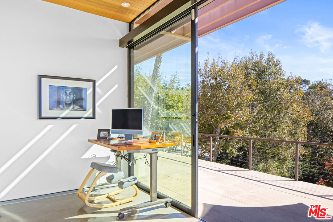 12321 Rochedale Lane Los Angeles, CA 90049 - Photo 16 of 46 a view of a workspace with a window