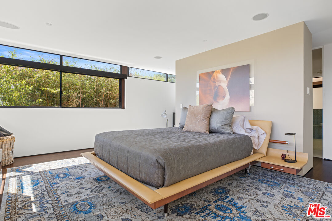12321 Rochedale Lane Los Angeles, CA 90049 - Photo 27 of 46 a bedroom with a bed and window