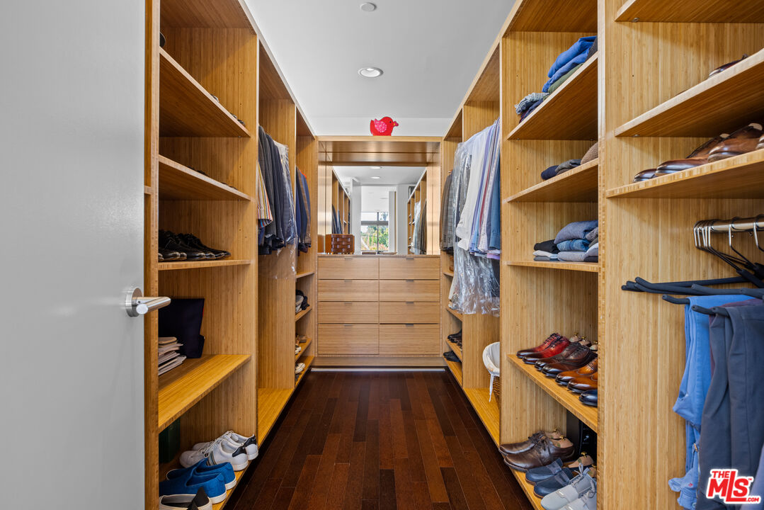 12321 Rochedale Lane Los Angeles, CA 90049 - Photo 29 of 46 a view of walk in closet with clothes and shoes