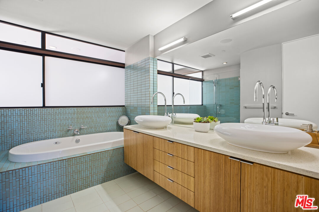 12321 Rochedale Lane Los Angeles, CA 90049 - Photo 30 of 46 a bathroom with a tub sink and mirror