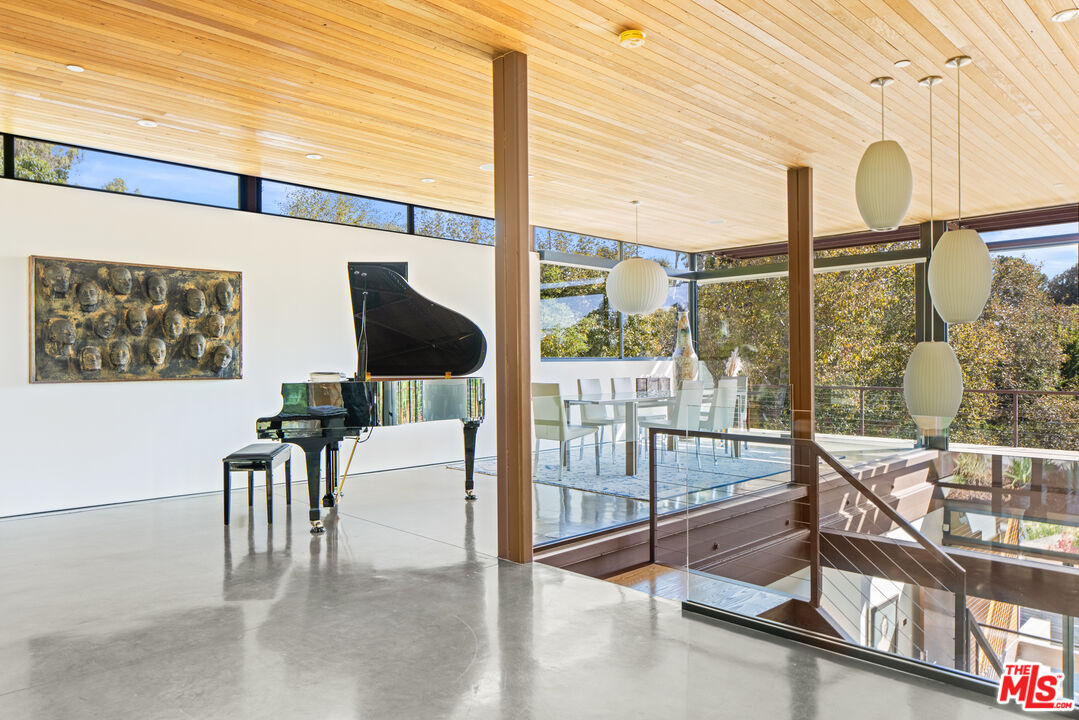 12321 Rochedale Lane Los Angeles, CA 90049 - Photo 4 of 46 a view of a living room with a floor to ceiling window and floor to ceiling window