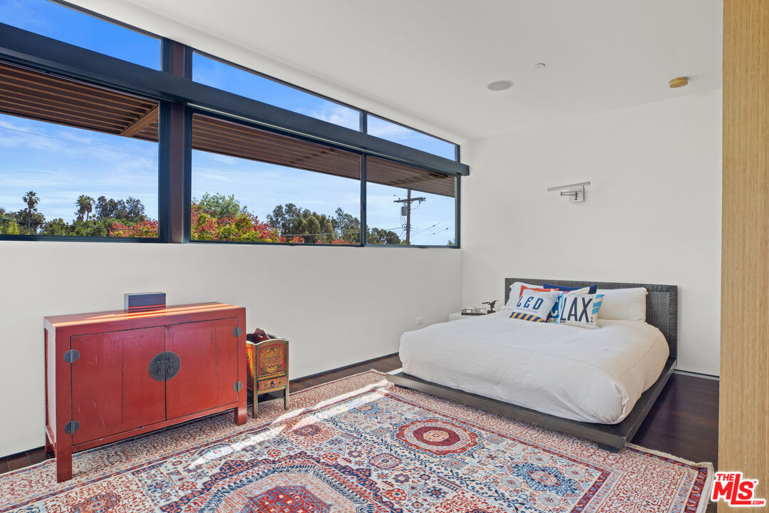 12321 Rochedale Lane Los Angeles, CA 90049 - Photo 31 of 46 a bedroom with a bed and a window