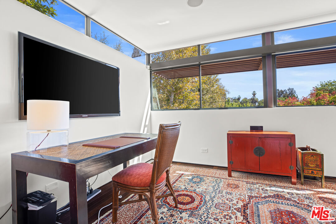 12321 Rochedale Lane Los Angeles, CA 90049 - Photo 32 of 46 a living room with table and a flat screen tv