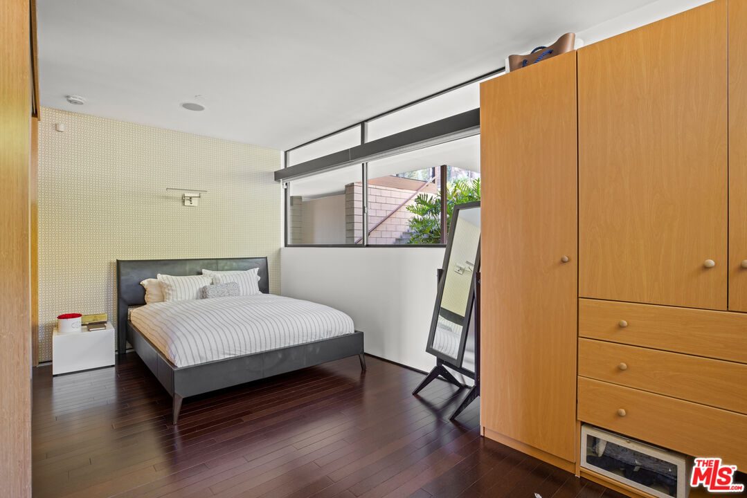 12321 Rochedale Lane Los Angeles, CA 90049 - Photo 35 of 46 a bedroom with a bed window and table