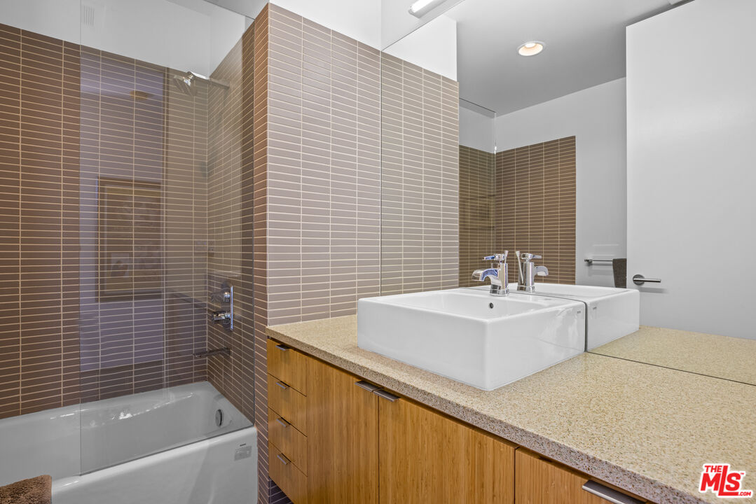 12321 Rochedale Lane Los Angeles, CA 90049 - Photo 36 of 46 a bathroom with a sink a bathtub and a mirror