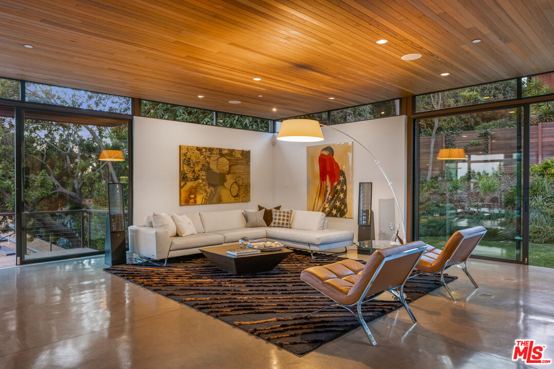 12321 Rochedale Lane Los Angeles, CA 90049 - Photo 39 of 46 a living room with furniture a rug and a large window