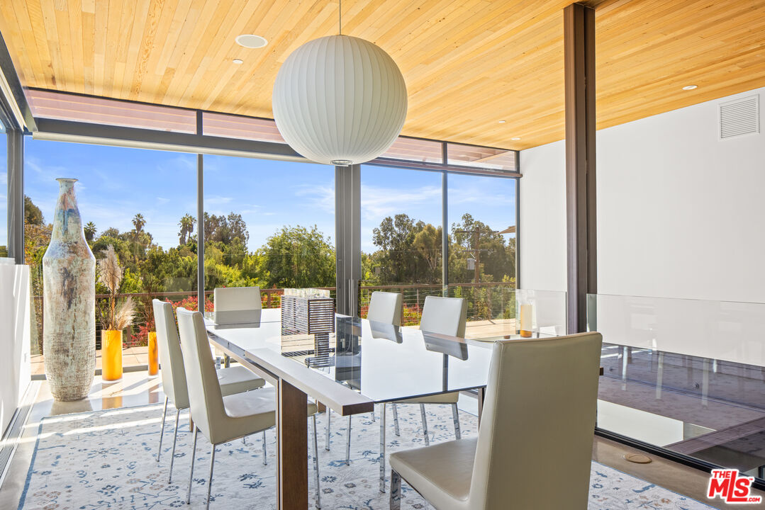 12321 Rochedale Lane Los Angeles, CA 90049 - Photo 7 of 46 a view of a dining room with furniture window and outside view