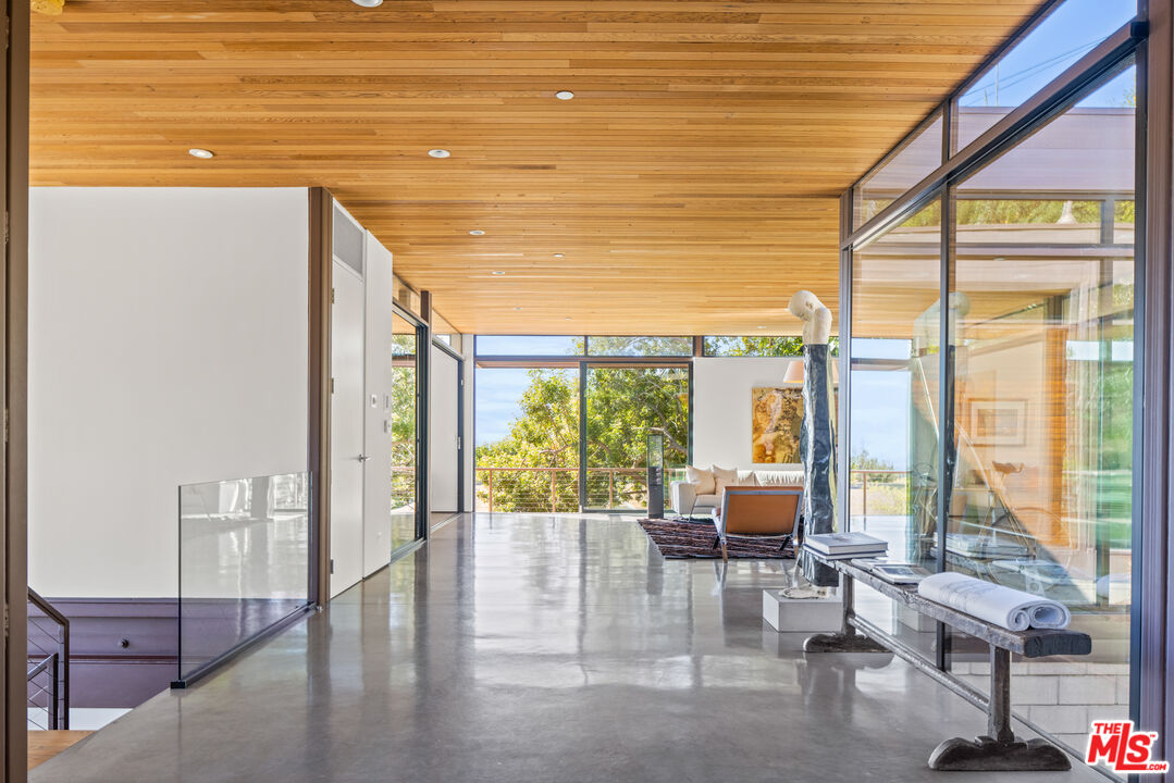 12321 Rochedale Lane Los Angeles, CA 90049 - Photo 8 of 46 a living room with furniture and floor to ceiling windows