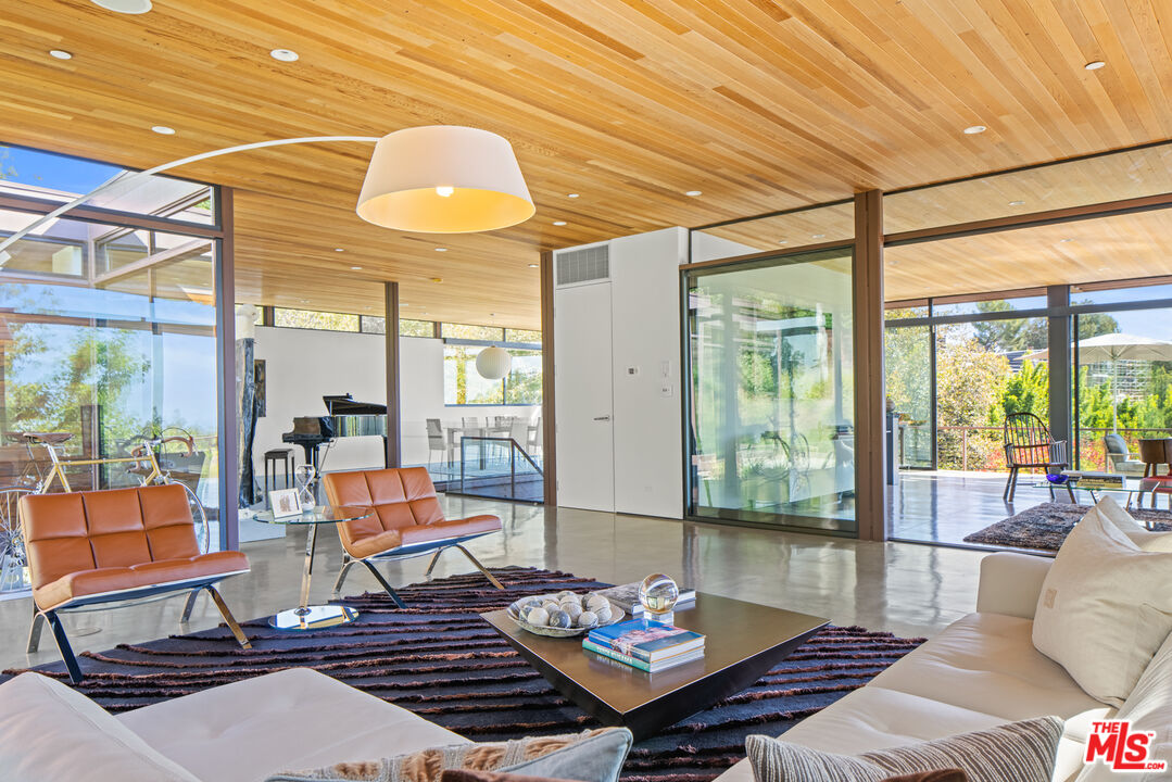 12321 Rochedale Lane Los Angeles, CA 90049 - Photo 9 of 46 a living room with furniture and floor to ceiling windows