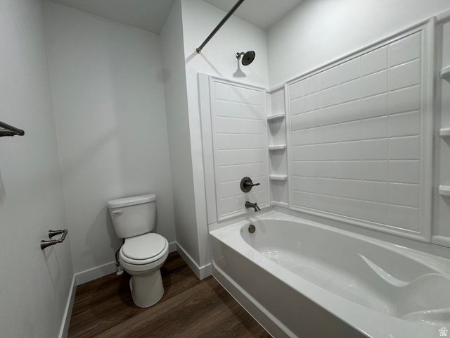1476 North 1875 West, Unit 152 Layton, UT 84041 - Photo 17 of 20 Bathroom featuring a white bathtub, white tiled shower surround with built-in shelving, dark bronze fixtures, and wood-finish flooring