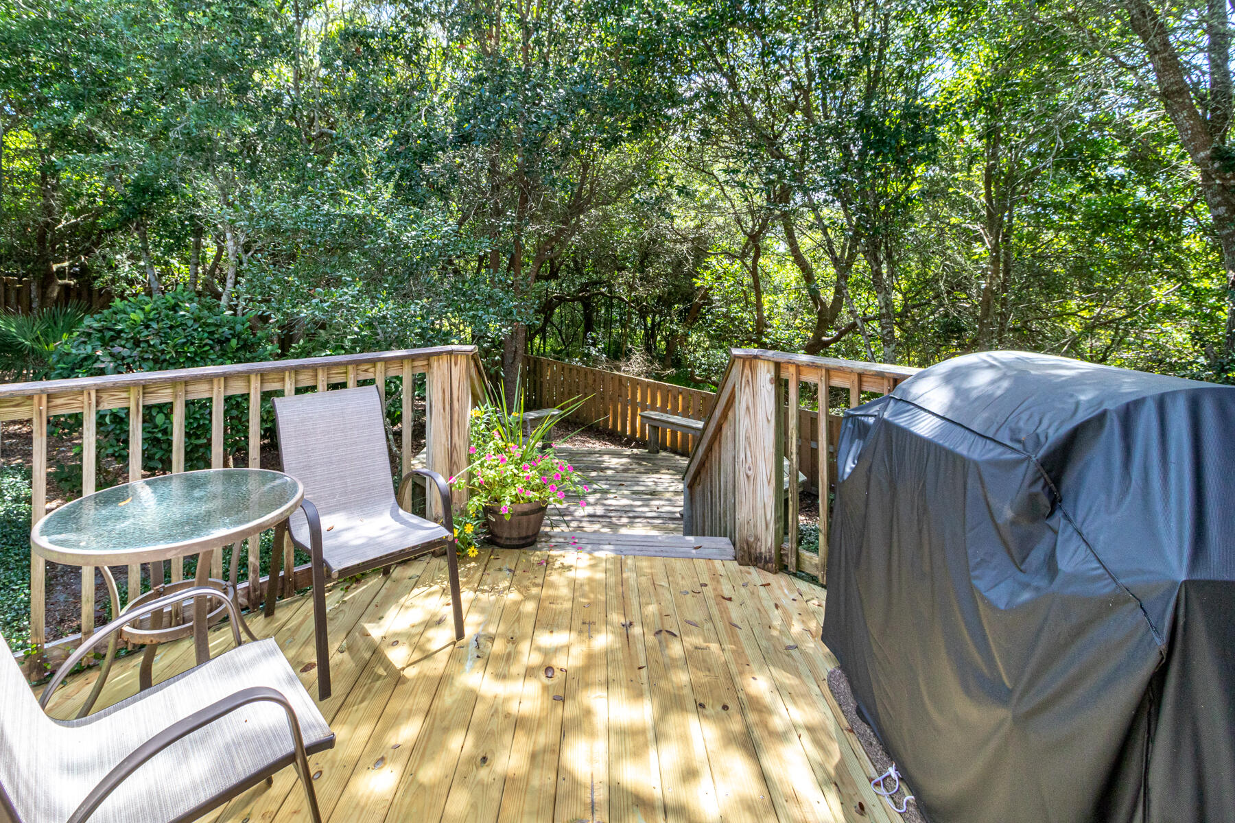 244 Baird Road Santa Rosa Beach, FL 32459 - Photo 25 of 63 a view of a patio with table and chairs with wooden floor and fence
