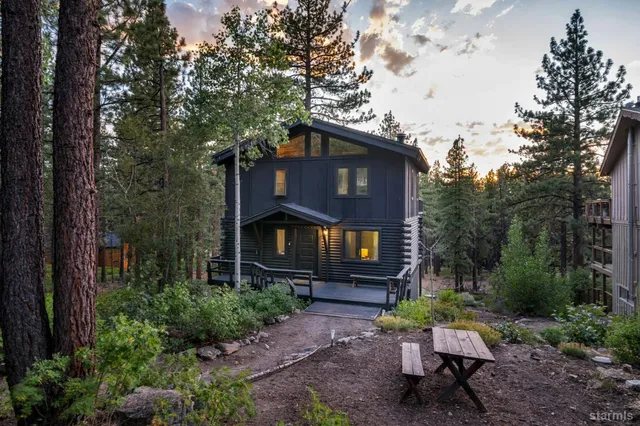 a front view of a house with yard and green space