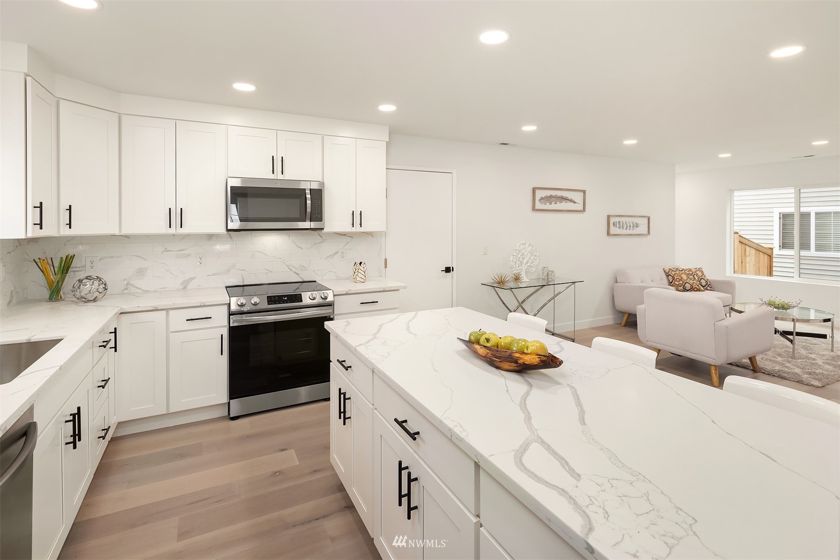 3820 153rd Place Southeast Bothell, WA 98012 - Photo 8 of 22 a kitchen with stainless steel appliances a stove a sink and white cabinets
