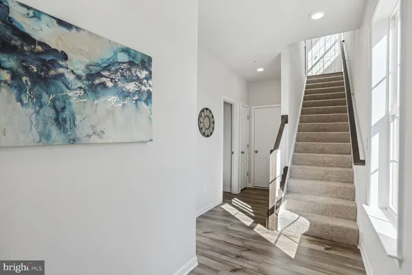 a view of entryway with stairs and wooden floor