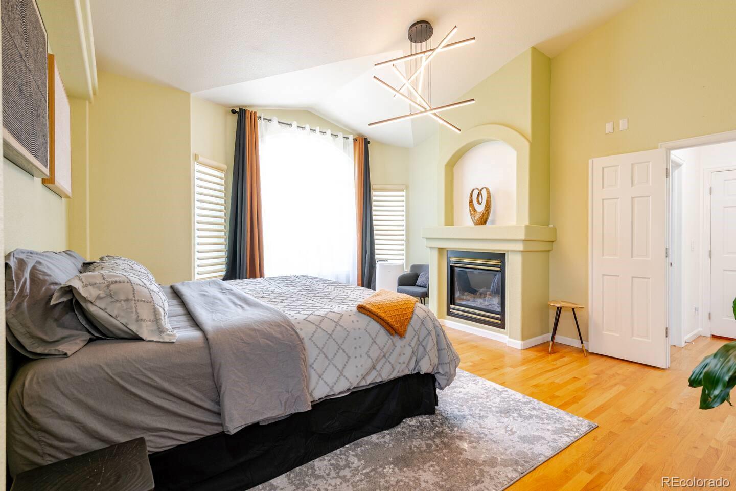 14532 Inca Court Westminster, CO 80023 - Photo 16 of 35 a bedroom with a bed and a fireplace