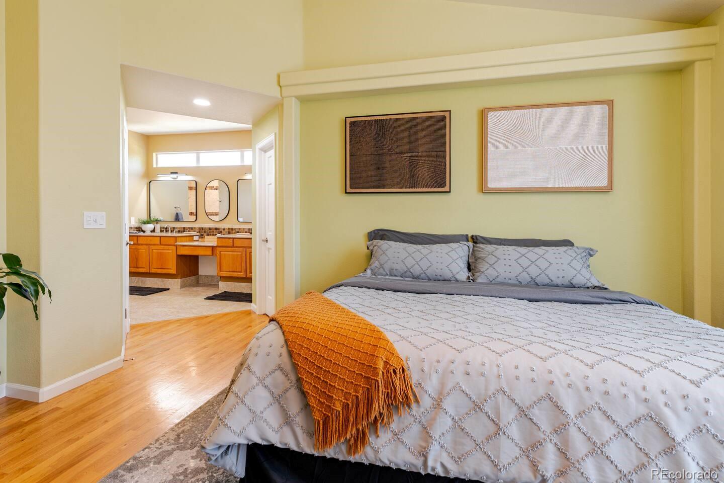 14532 Inca Court Westminster, CO 80023 - Photo 17 of 35 a bedroom with a bed and a view of bathroom