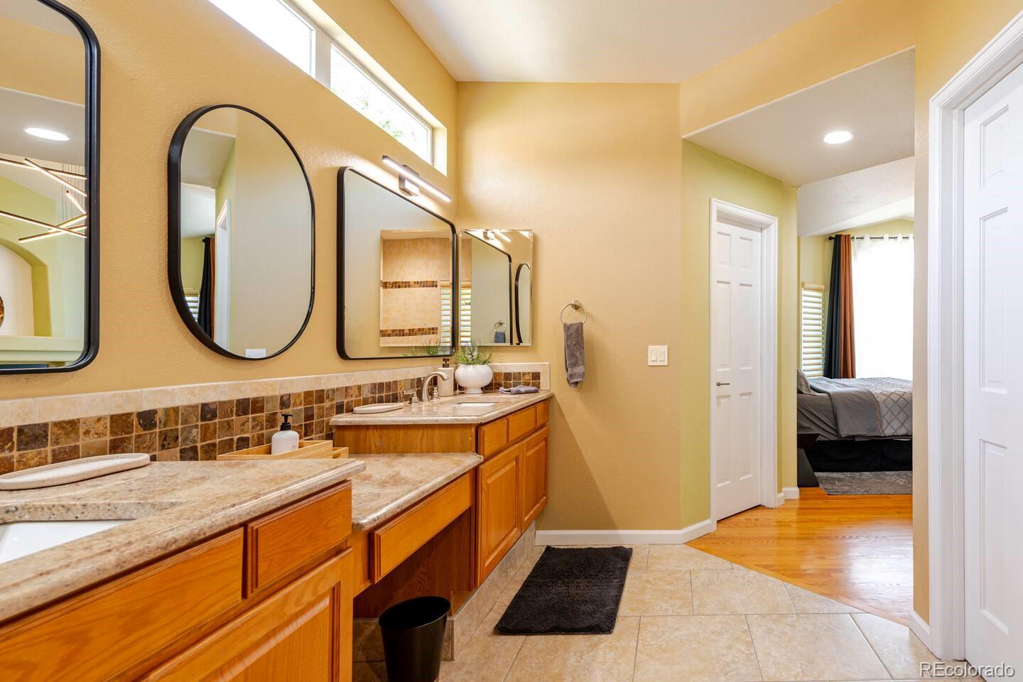 14532 Inca Court Westminster, CO 80023 - Photo 18 of 35 a bathroom with a double vanity sink and a mirror