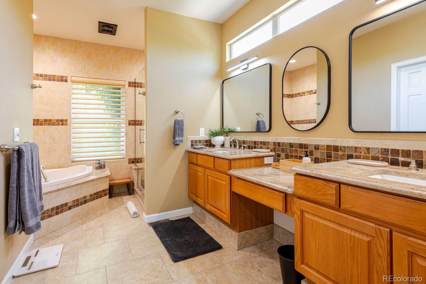 14532 Inca Court Westminster, CO 80023 - Photo 19 of 35 a spacious bathroom with a double vanity sink and a mirror