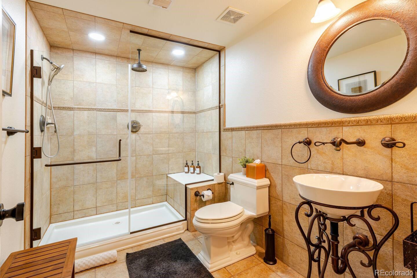 14532 Inca Court Westminster, CO 80023 - Photo 21 of 35 a bathroom with a toilet a sink and a mirror