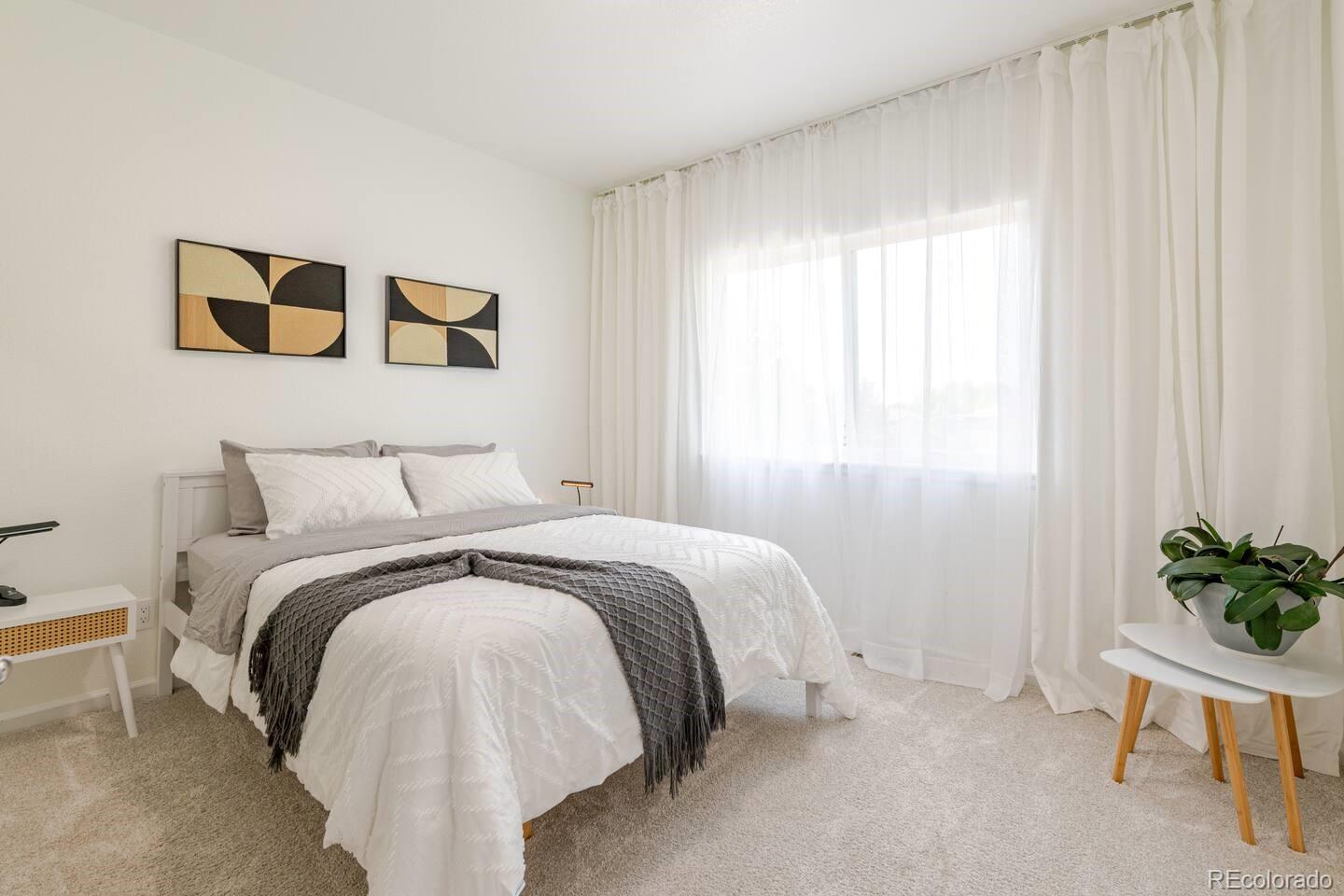 14532 Inca Court Westminster, CO 80023 - Photo 24 of 35 a bedroom with a bed and a chair