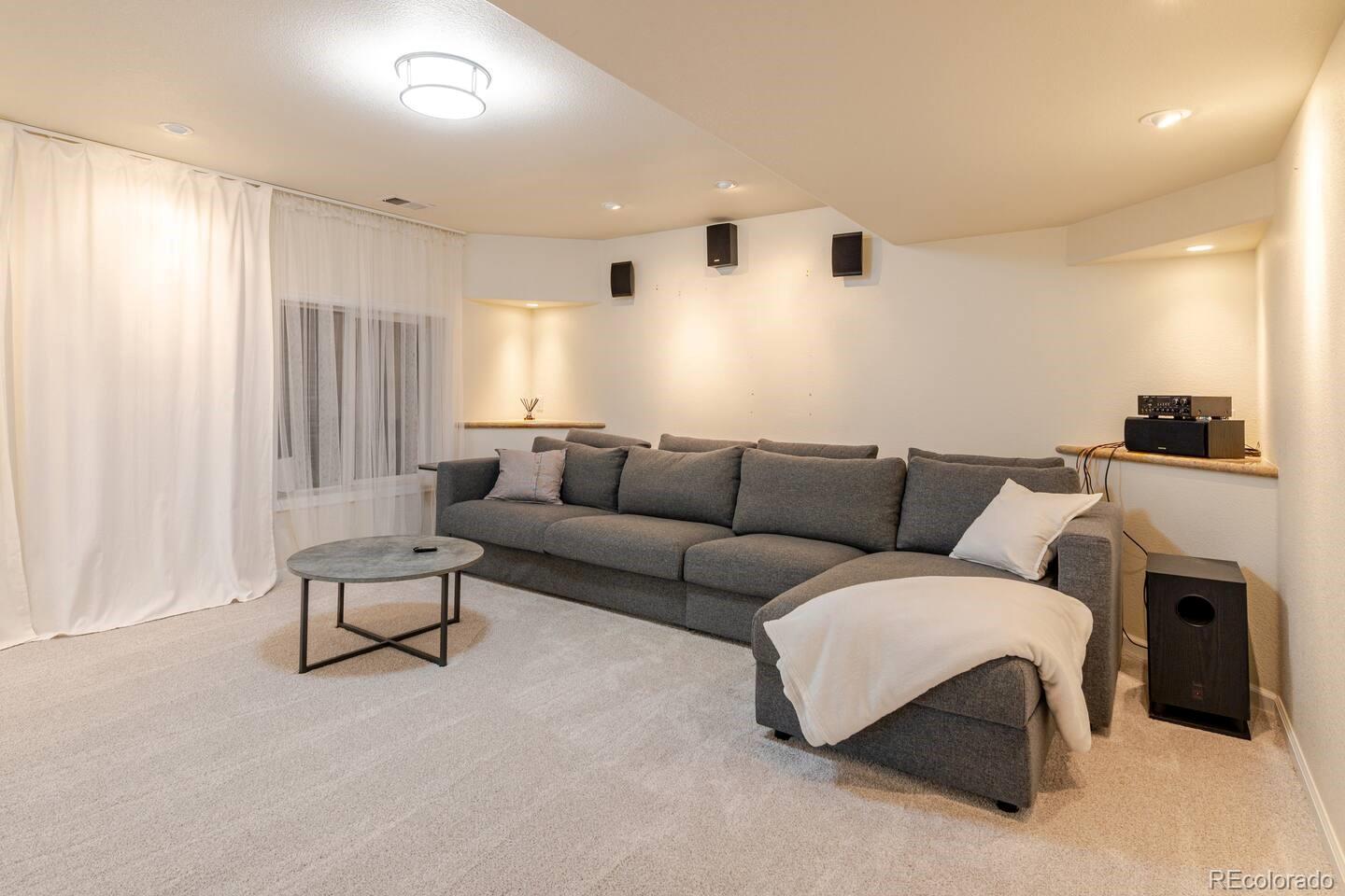 14532 Inca Court Westminster, CO 80023 - Photo 26 of 35 a living room with furniture and a flat screen tv