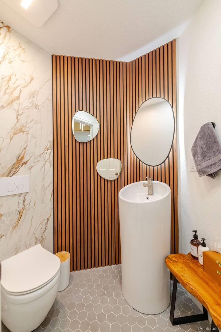 14532 Inca Court Westminster, CO 80023 - Photo 10 of 35 a bathroom with a toilet a sink and mirror