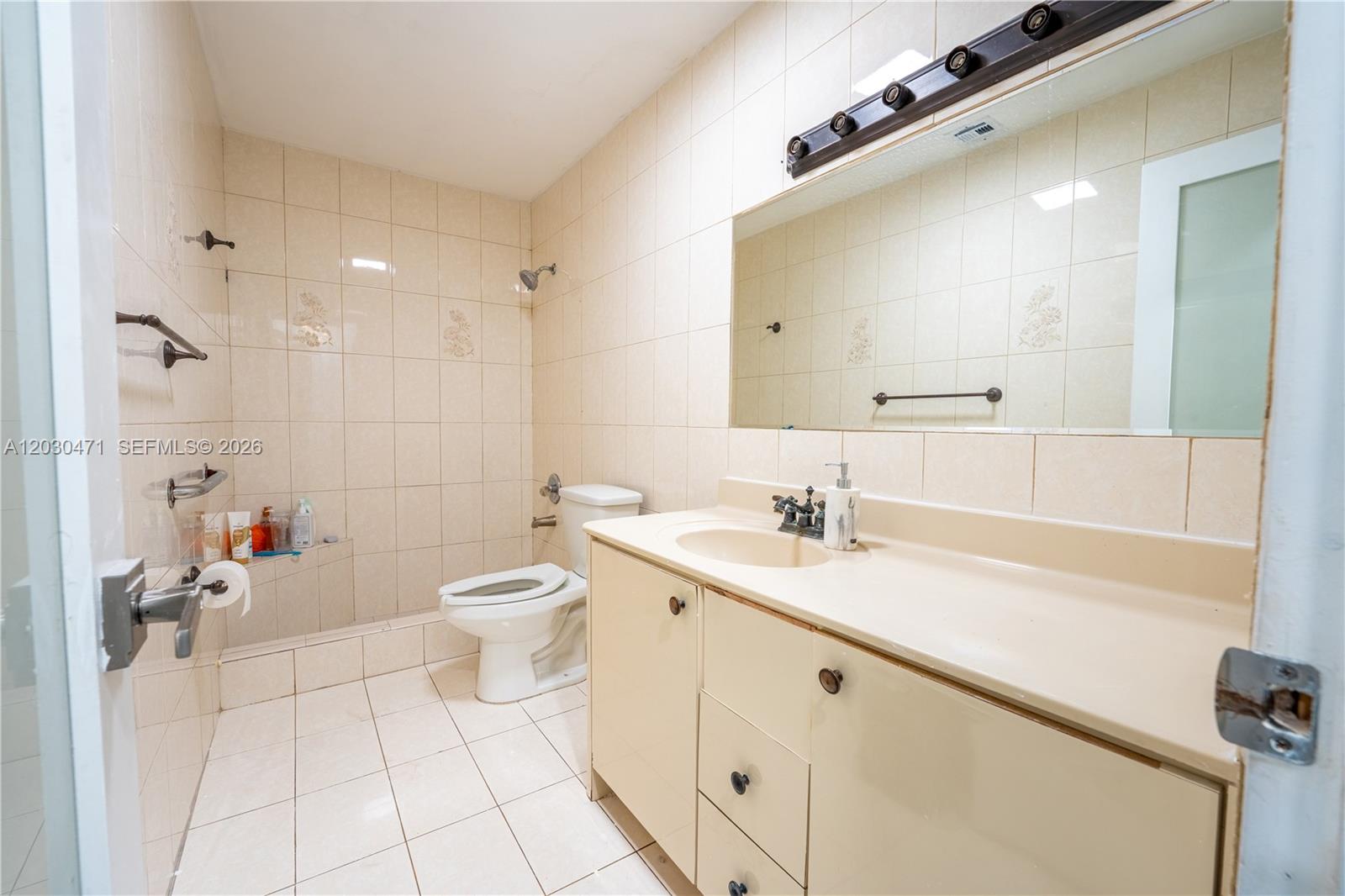 11851 Southwest 181st Street Miami, FL 33177 - Photo 23 of 25 a bathroom with a granite countertop sink a toilet and a mirror