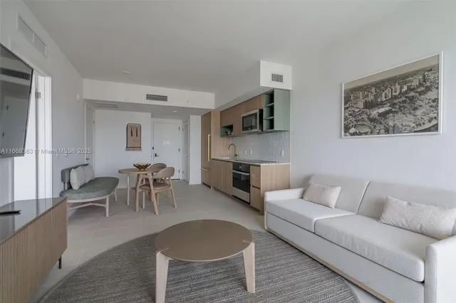 a living room with furniture a dining table and a fireplace