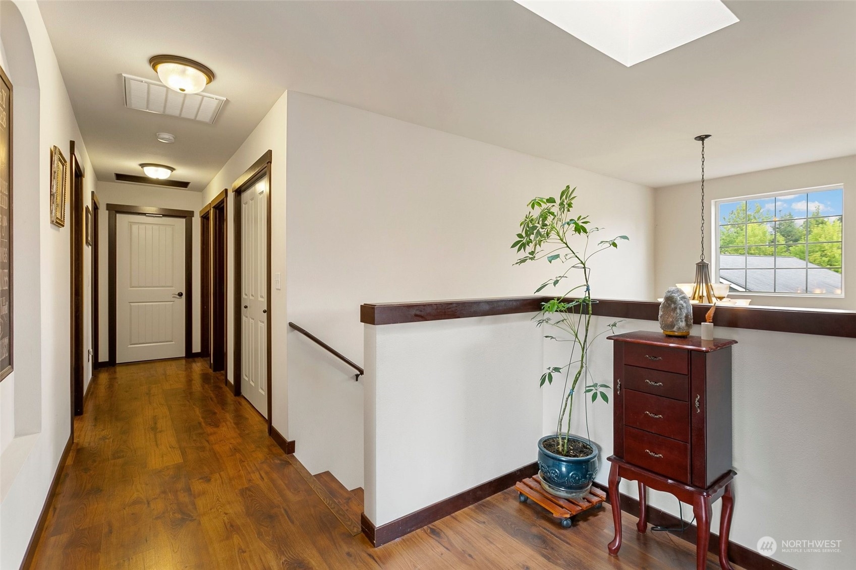 408 171st Street Southeast Bothell, WA 98012 - Photo 15 of 31 a view of a hallway with wooden floor and furniture
