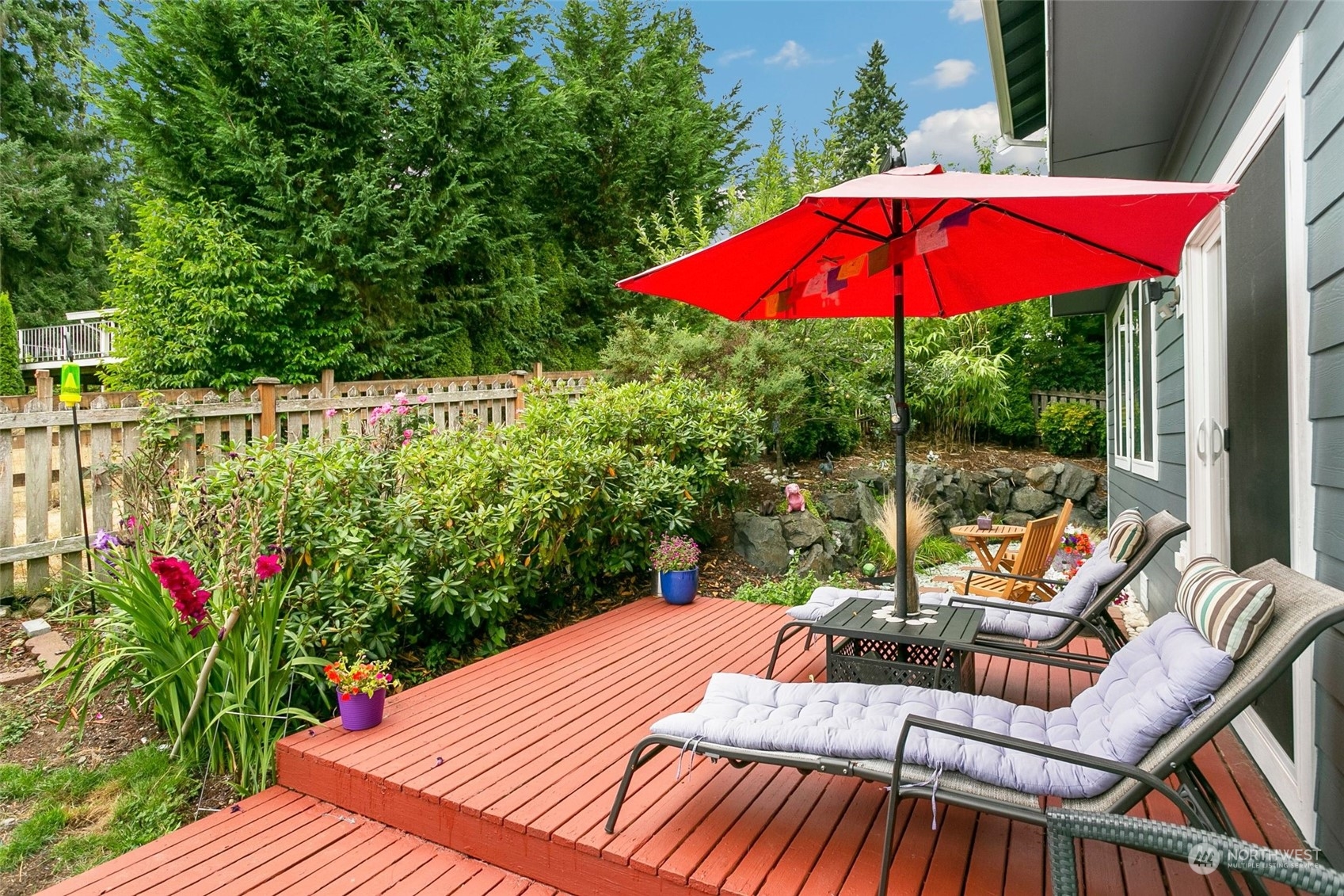 408 171st Street Southeast Bothell, WA 98012 - Photo 28 of 31 a view of a patio with couches chairs under an umbrella