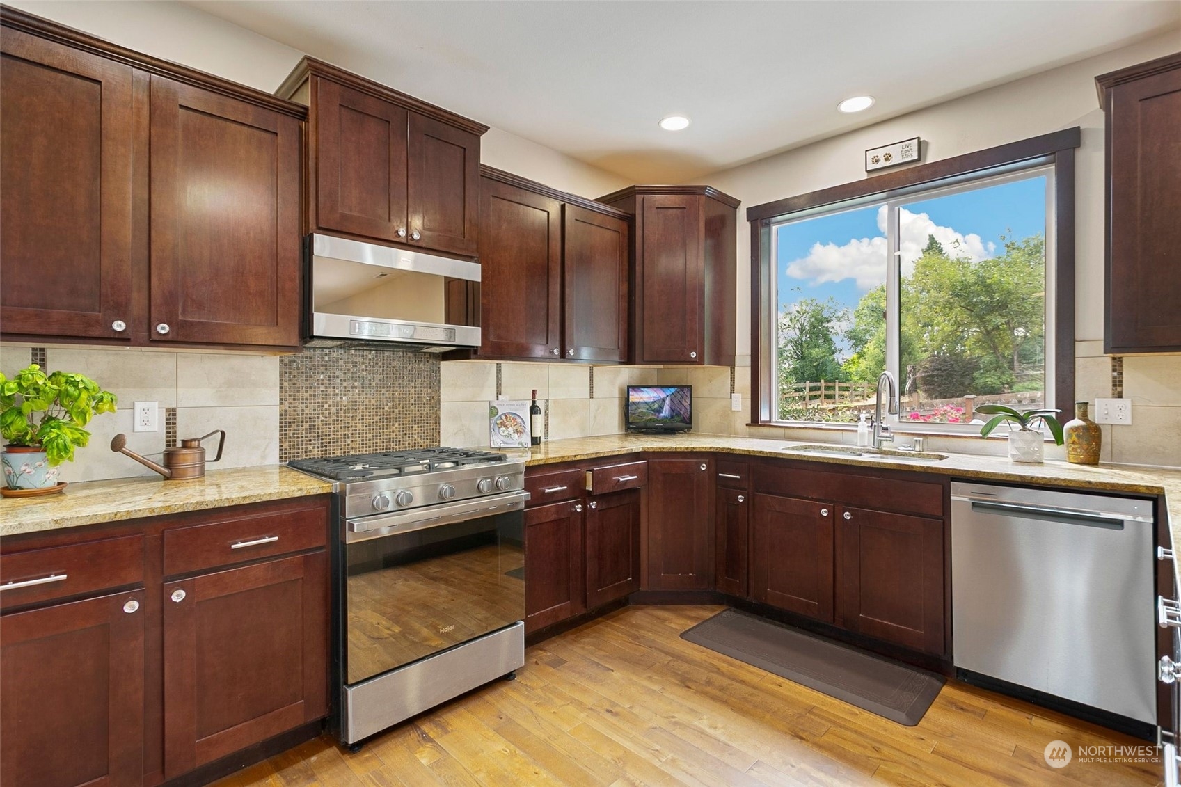 408 171st Street Southeast Bothell, WA 98012 - Photo 7 of 31 a kitchen with kitchen island granite countertop wooden cabinets a sink and a stove